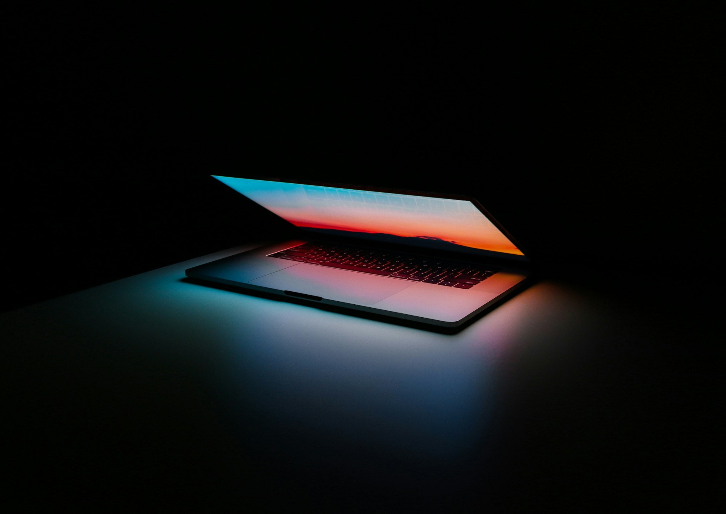 Premium laptop workspace in moody blue light